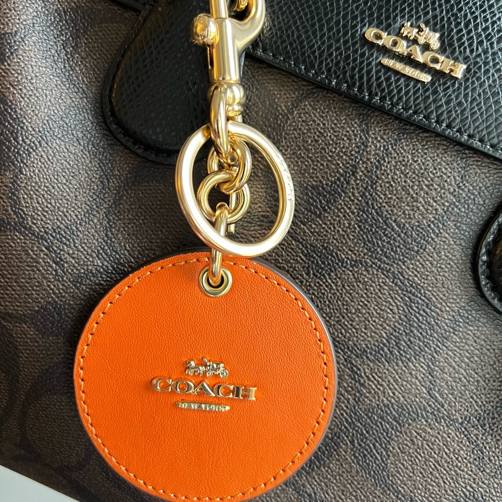 Coach Mirror Bag Charm in gorgeous fall colour of orange. Excellent condition.